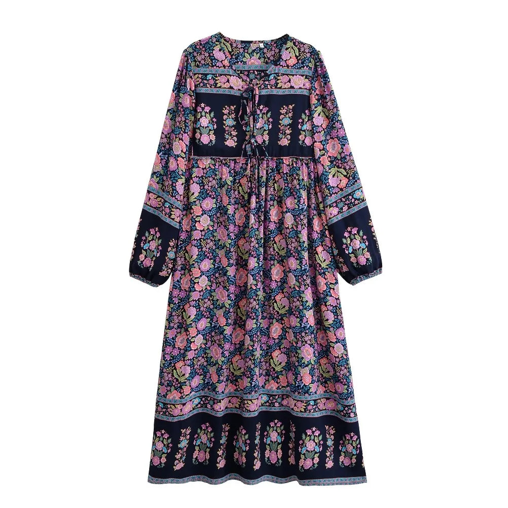 A bohemian floral maxi dress featuring pink, blue, and green floral patterns with lantern sleeves.