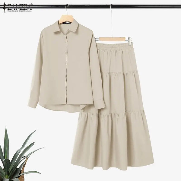 A beige elegant modest shirt and tiered skirt set displayed on a hanger.