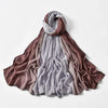 Drapierter Schal in Mauve- und Lilatönen.