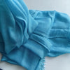 Foulard hijab en coton viscose bleu doux, drapé et plié avec une pompon.