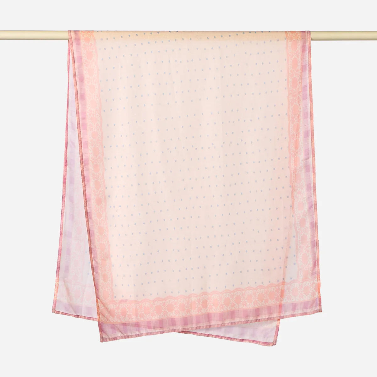 A sheer pink printed linen hijab scarf draped over a hanger.