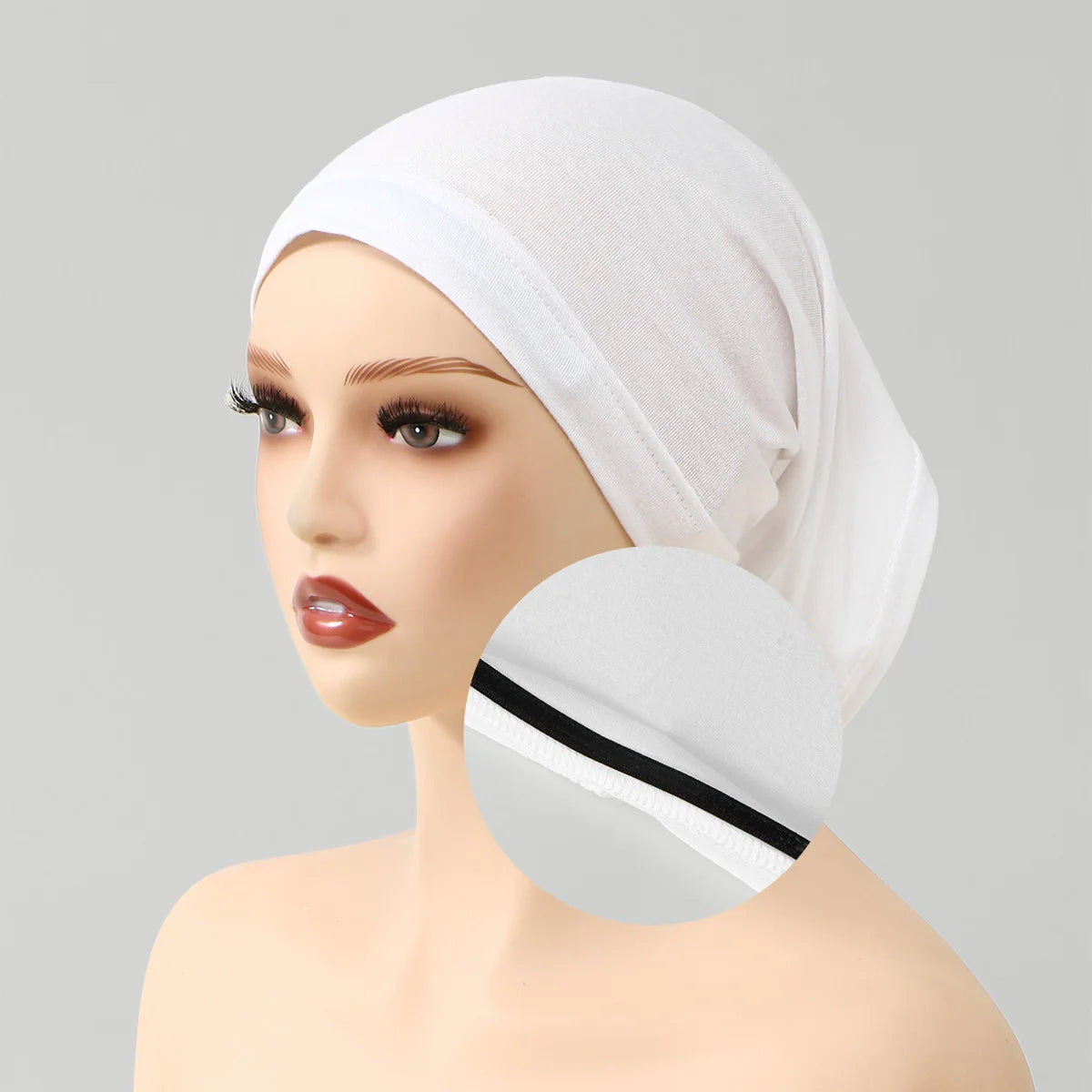 A white anti-slip inner hijab cap is shown on a mannequin head.