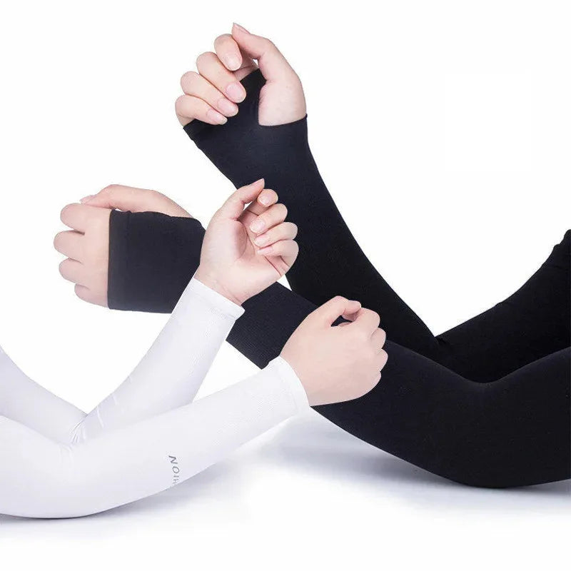 A pair of black and white cooling UV protection arm sleeves being worn by a person.