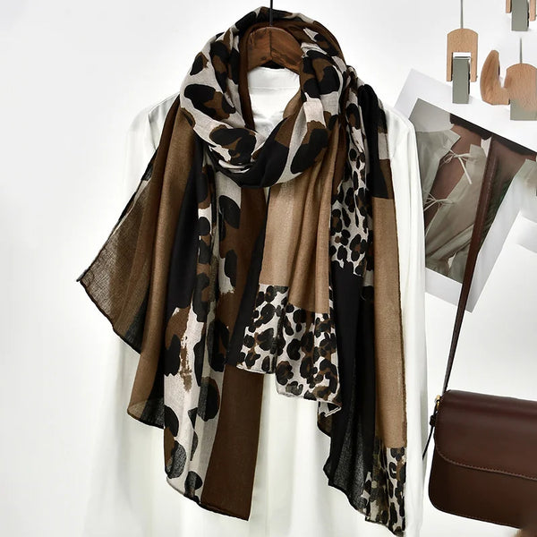 A brown and black leopard print viscose shawl draped around a white top.