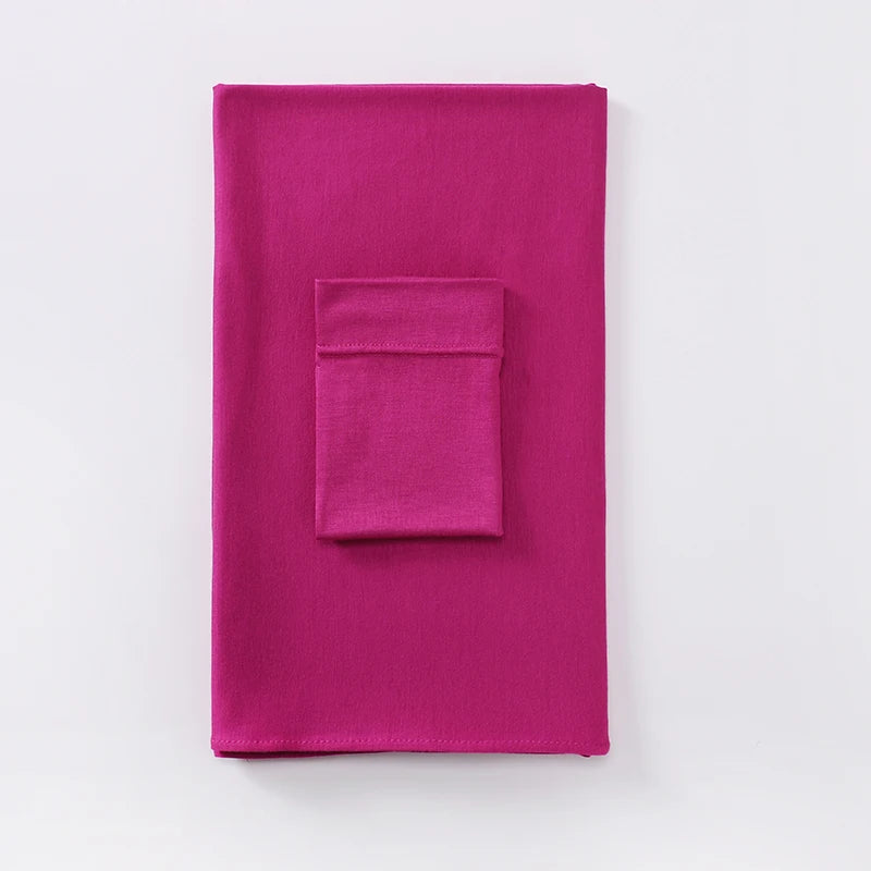 Un vibrante conjunto de pañuelo jersey magenta de dos piezas con un cuadrado de tela a juego.