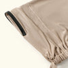 A close-up of a beige anti-slip inner hijab cap with a black trim and gathered fabric detail.