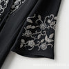 Black fabric with silver floral beaded embroidery on the sleeve of a luxury abaya set