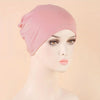 A pink classic stretch jersey turban cap displayed on a white mannequin head.