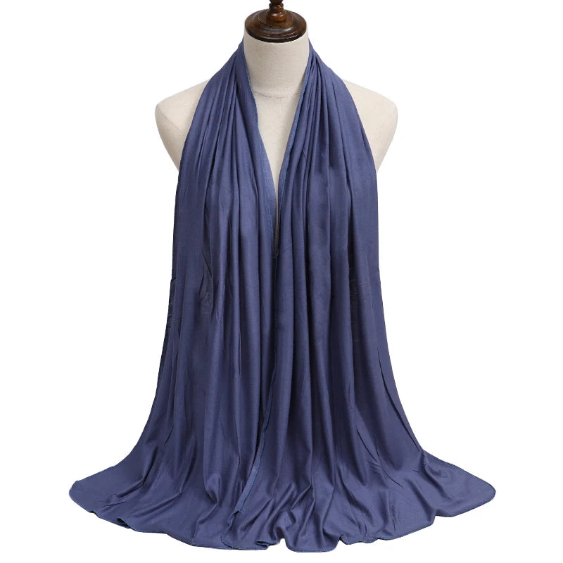 A deep blue premium modal jersey hijab draped around a mannequin's neck.