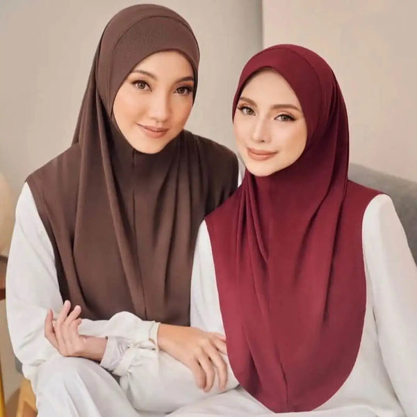 Two women wearing instant Islamic hijab scarves, one brown and one maroon, sitting together.