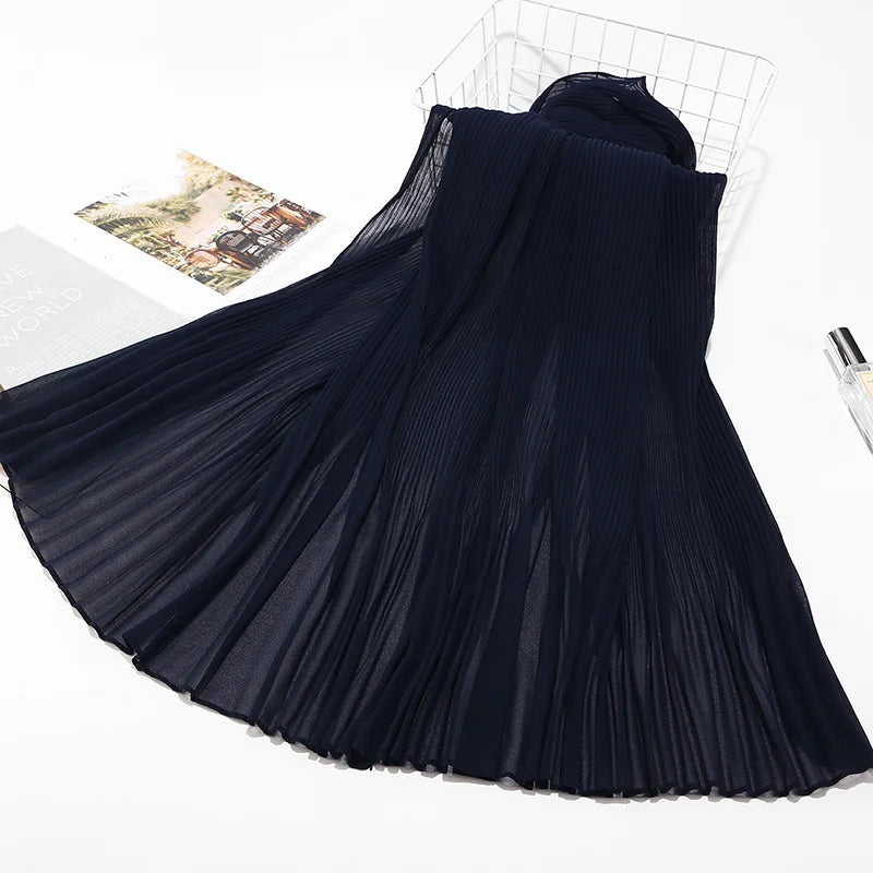 Dunkelblaue Crinkle-Chiffon-Hijab-Schal, drapiert und auf weißem Hintergrund.