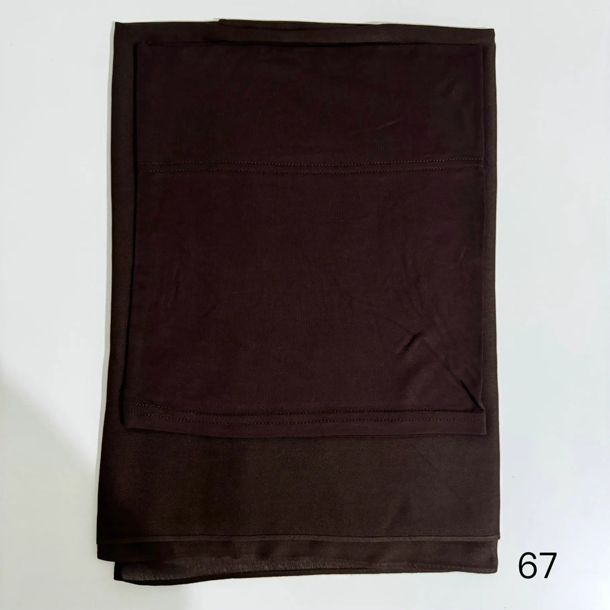 A dark brown soft modal rayon hijab set folded neatly.