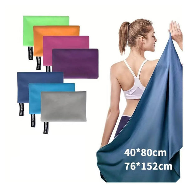 A woman is demonstrating a blue microfiber travel towel alongside various colored towels.