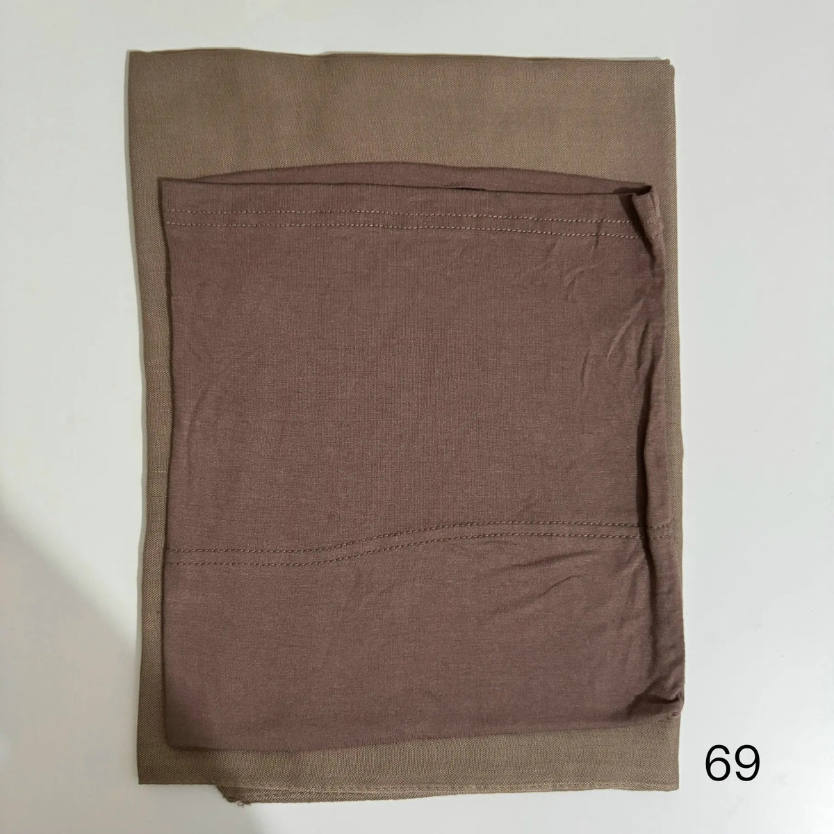 A solid brown soft modal rayon hijab set folded neatly.