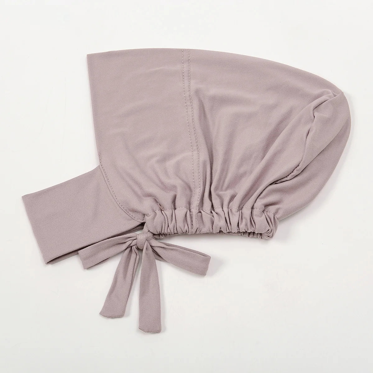A soft mauve inner hijab cap scarf made of cotton polyester with a gathered knot detail.