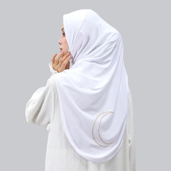 A white hijab scarf with a golden crescent moon embroidery is draped over a person's head.