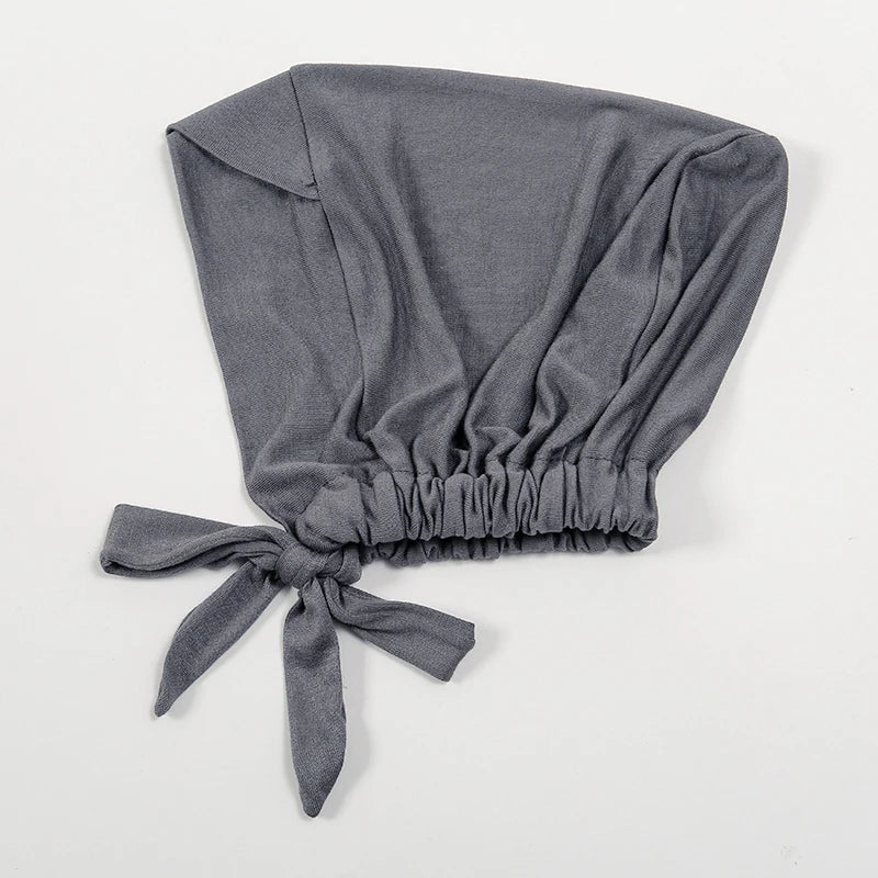 A solid gray adjustable cotton jersey inner hijab cap tied at the bottom.