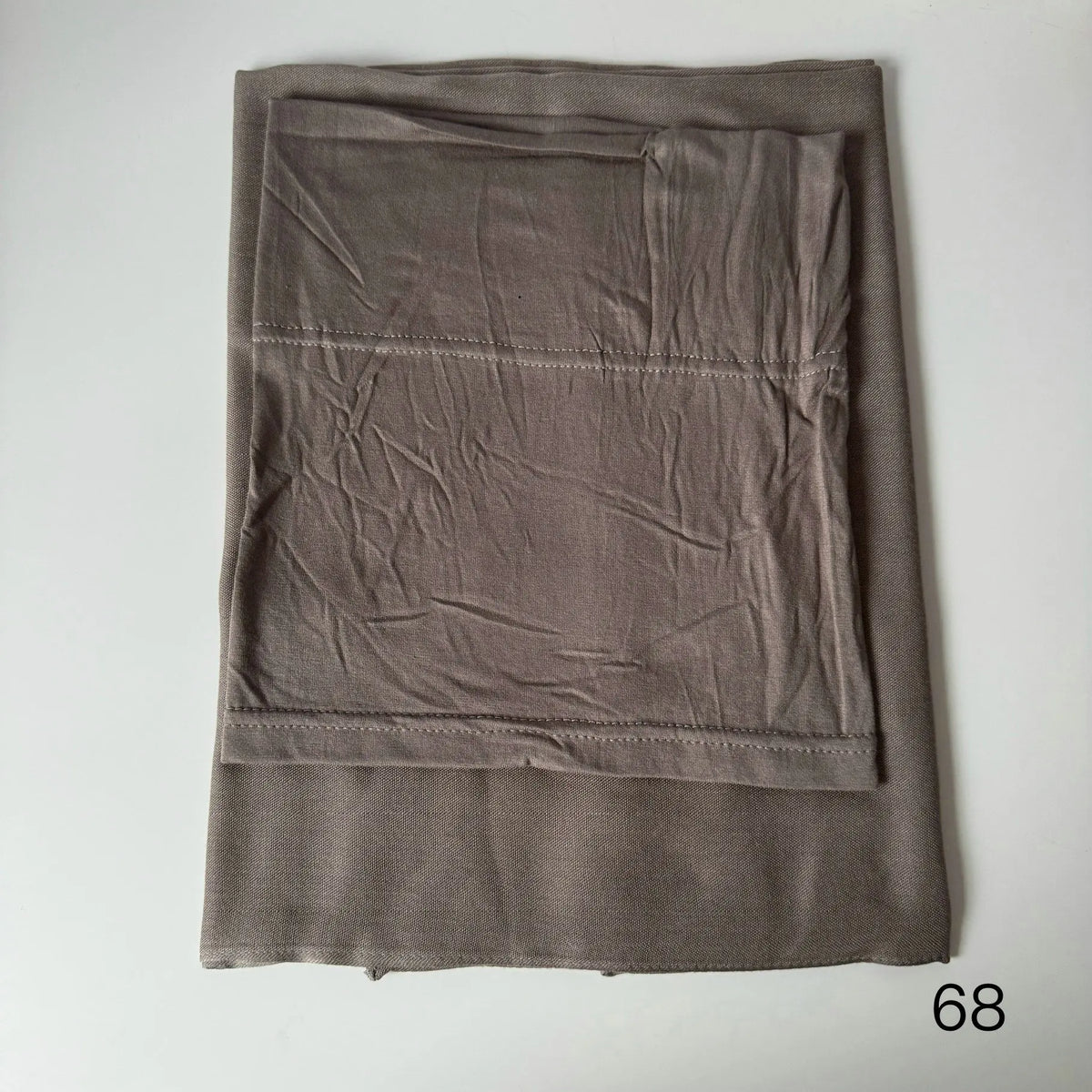 A folded, solid taupe soft modal rayon hijab set for women.