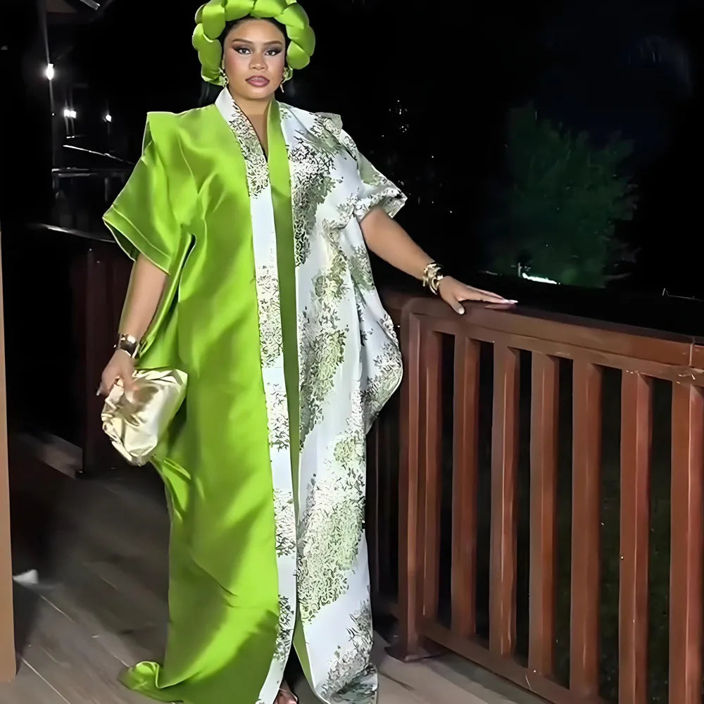A woman wearing an elegant, flowing lime green kaftan with white tatting detail, standing on a balcony.