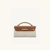 A tan leather shoulder bag with a crocodile pattern and gold hardware.