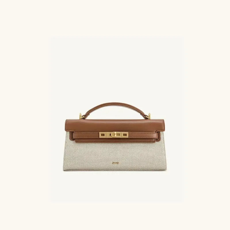 A tan leather shoulder bag with a crocodile pattern and gold hardware.