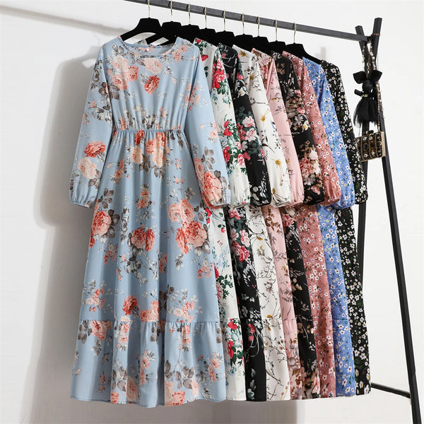 A display of various bohemian floral print maxi dresses hanging on a rack.