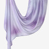 A purple and white printed linen hijab scarf draped elegantly.