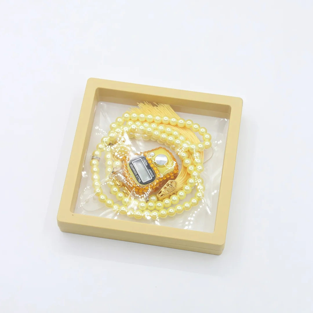 A set of Islamic tasbih prayer beads and digital counter bracelets displayed in a light wood tray.