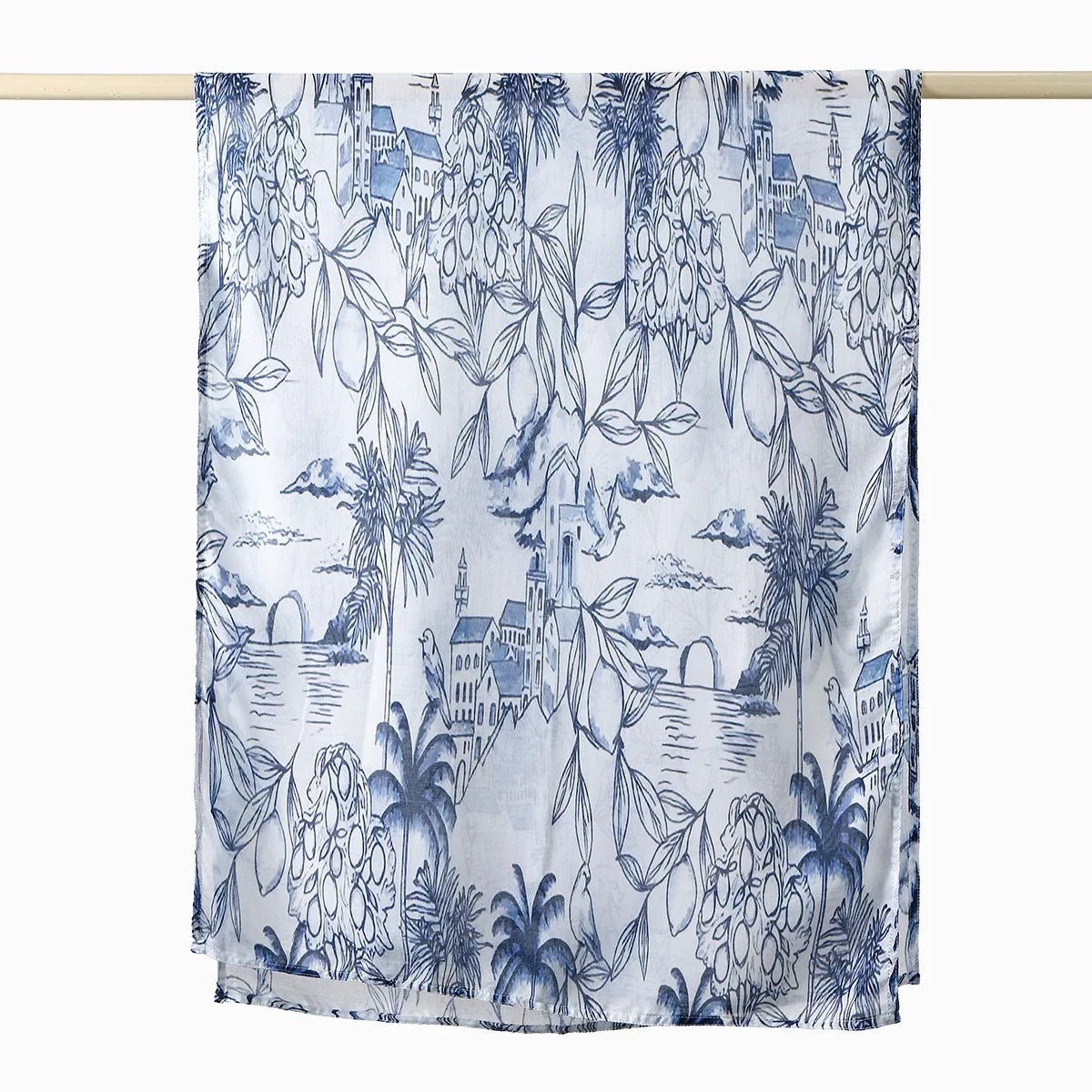 Elegant printed linen hijab scarf featuring blue botanical and cityscape patterns