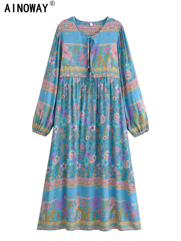 A long-sleeved bohemian floral maxi dress in shades of blue, pink, and green.