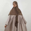 A woman wearing a beige large size stretchy modal square scarf and matching dress for Islamic wear.