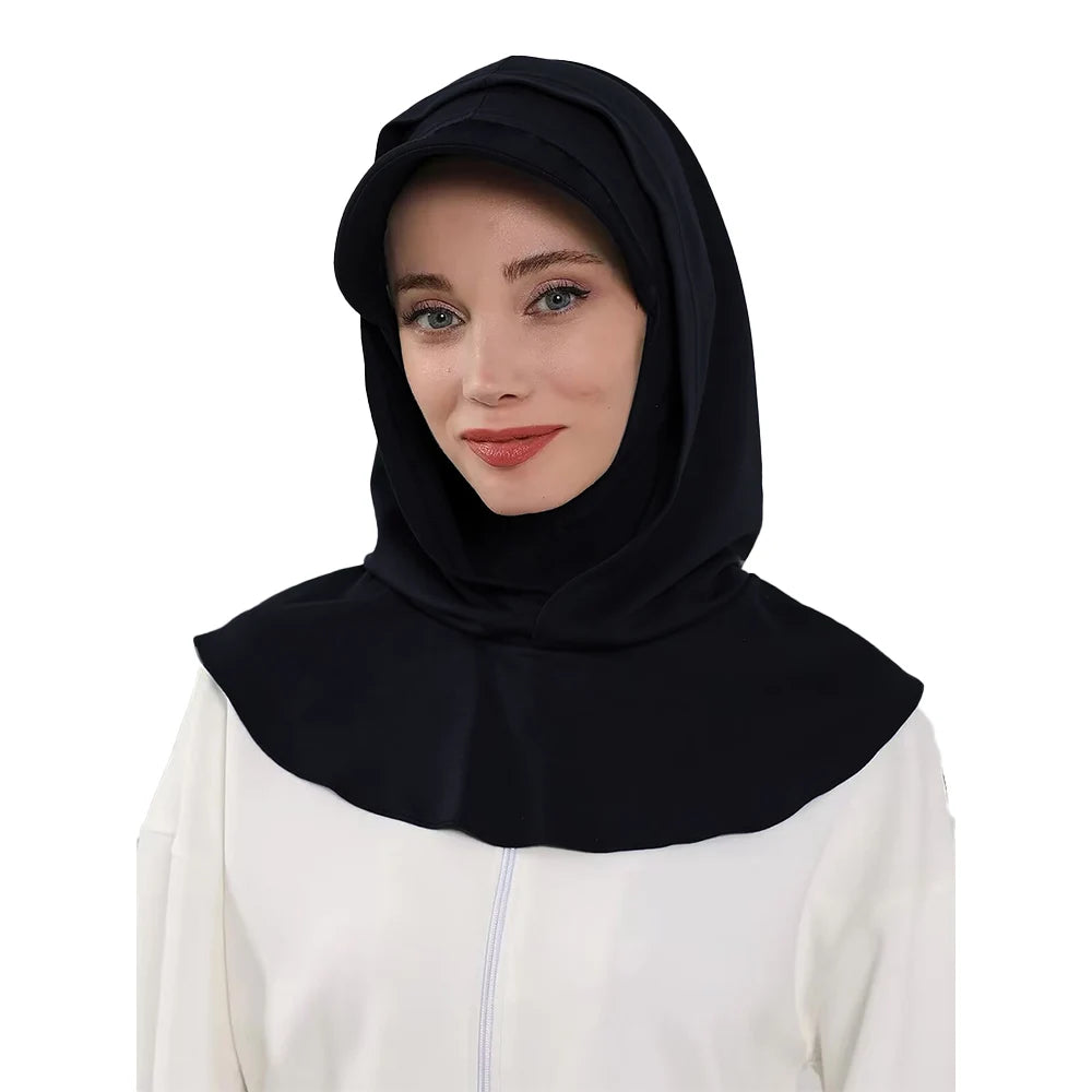Une femme portant un bonnet hijab noir couvrant et un haut blanc.