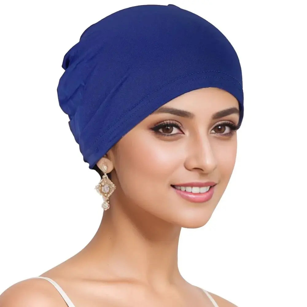 A woman wearing a royal blue breathable cotton underscarf with an elastic fit
