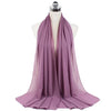 A mauve chiffon hijab scarf draped around a mannequin neck.