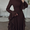 A dark brown elegant high-waisted long-sleeve A-line maxi dress shown on a model.
