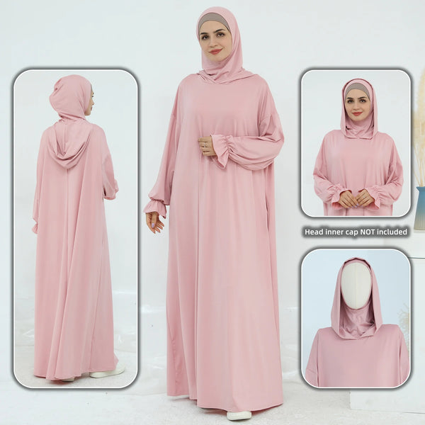 A woman wearing a flowing, loose-fit pink abaya dress for prayer, shown from the front and back.