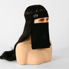Model wearing a black face veil and a black headband with a crown design.