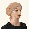 Ein Model trägt einen beige Hijab mit einem verziertem Strassband auf der Stirn und einem schwarzen Oberteil.