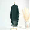 A dark green ruffled two-layer chiffon hijab displayed on a hanger against a white background.
