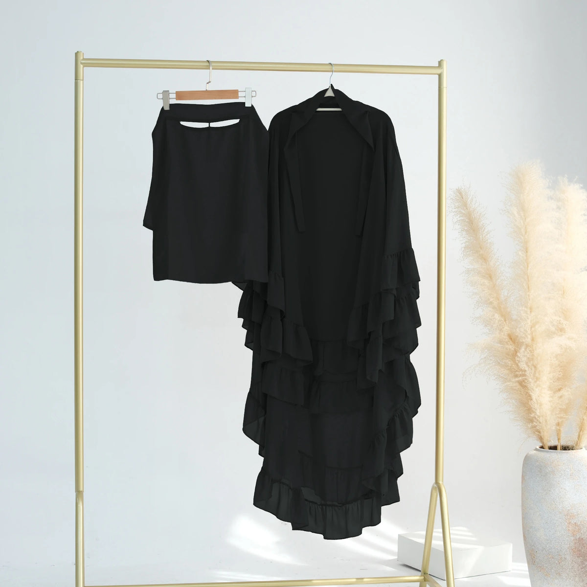 Black ruffled 2-layer chiffon hijab displayed on a gold hanger against a white background.