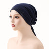 A woman wearing a navy blue adjustable elastic headband hijab cap on a mannequin head.