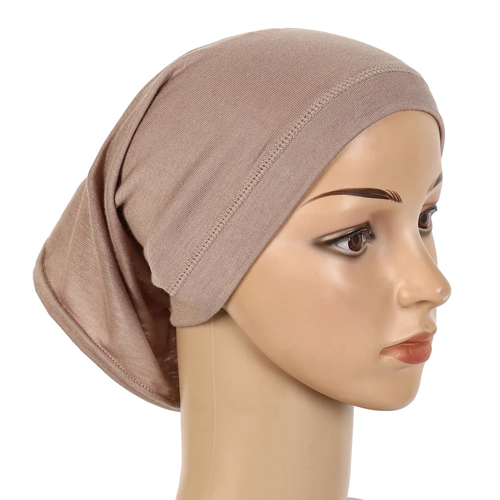 A beige chiffon instant hijab is shown draped on a mannequin head.
