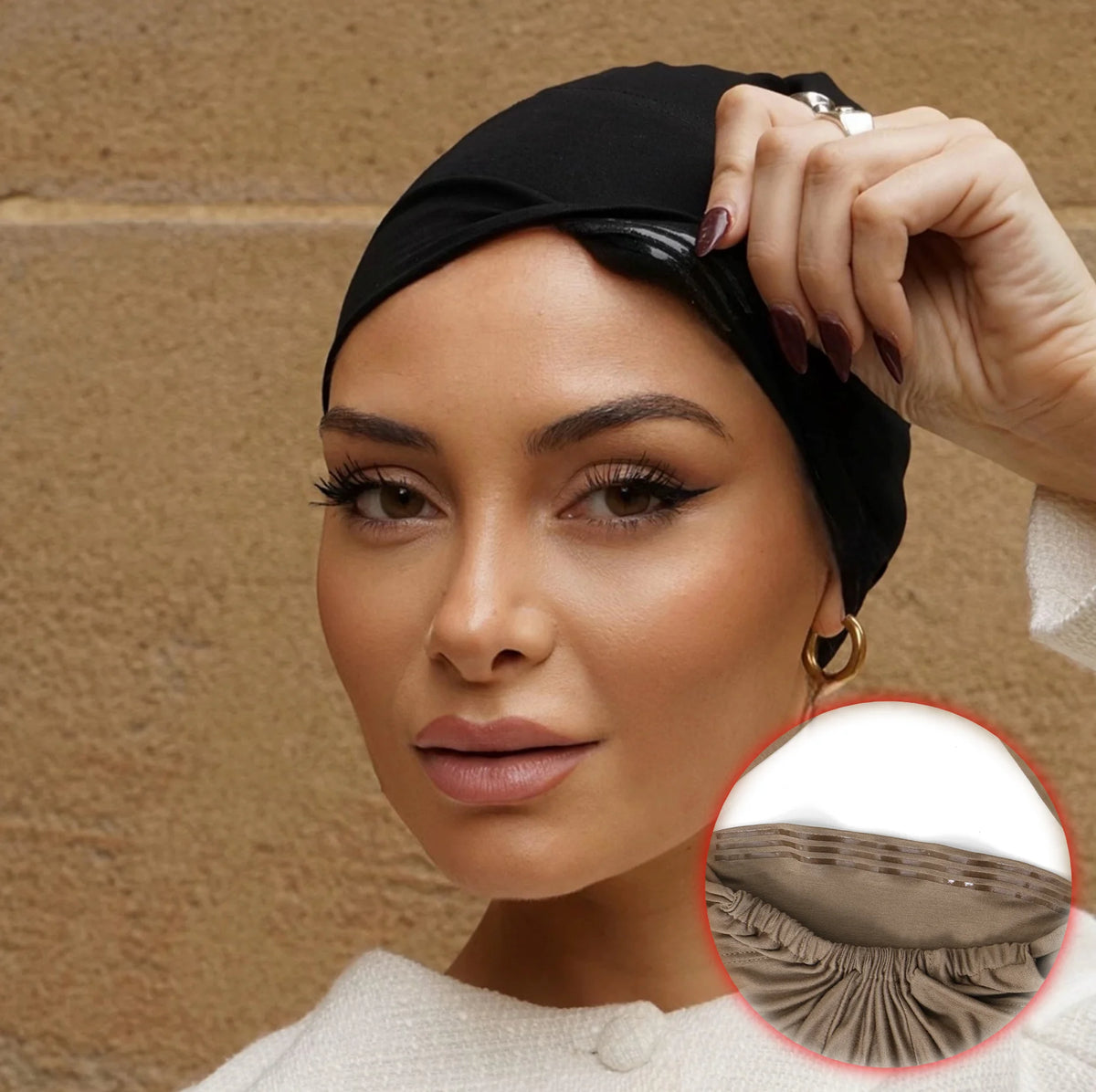 A woman wearing a black adjustable elastic headband hijab cap, looking directly at the camera.