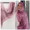 Model wearing a sheer pink watercolor ombre rayon modal hijab scarf draped over head and shoulders.