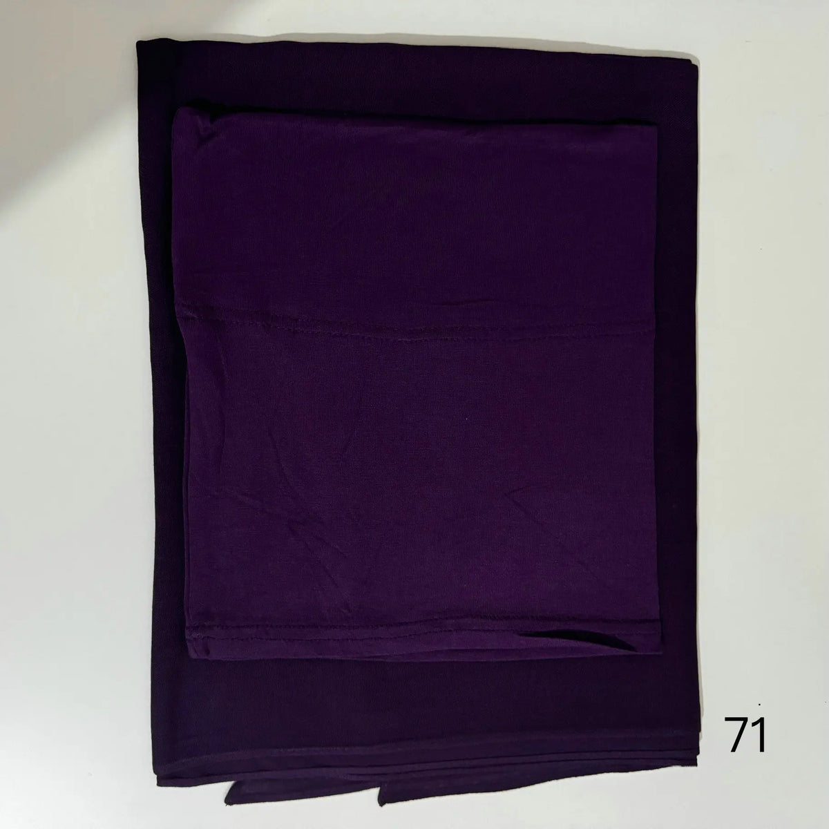 A folded deep purple soft modal rayon hijab set for women.