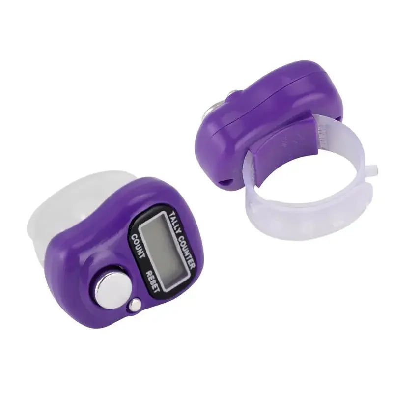 A purple mini digital finger counter with a clear silicone band and a white housing.