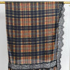A plaid hijab scarf featuring shades of brown, orange, and navy blue with black lace trim.