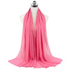 A bright pink chiffon hijab scarf draped around a mannequin's neck.