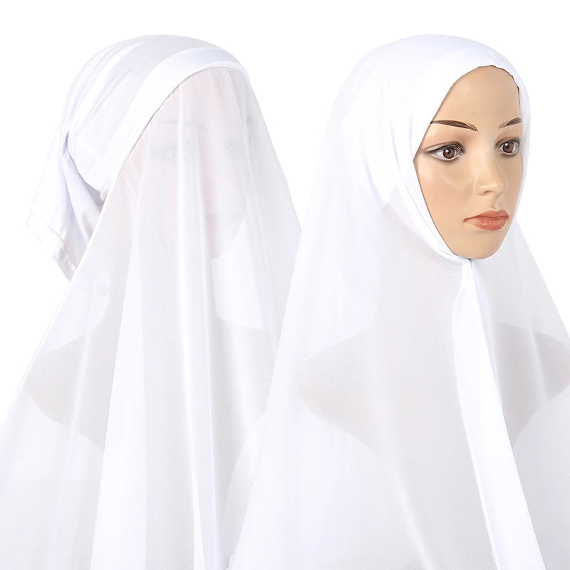 A woman wearing a white chiffon instant hijab with a modal cotton cap.