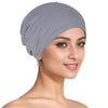 A woman wearing a gray breathable cotton underscarf with an elastic fit on her head.